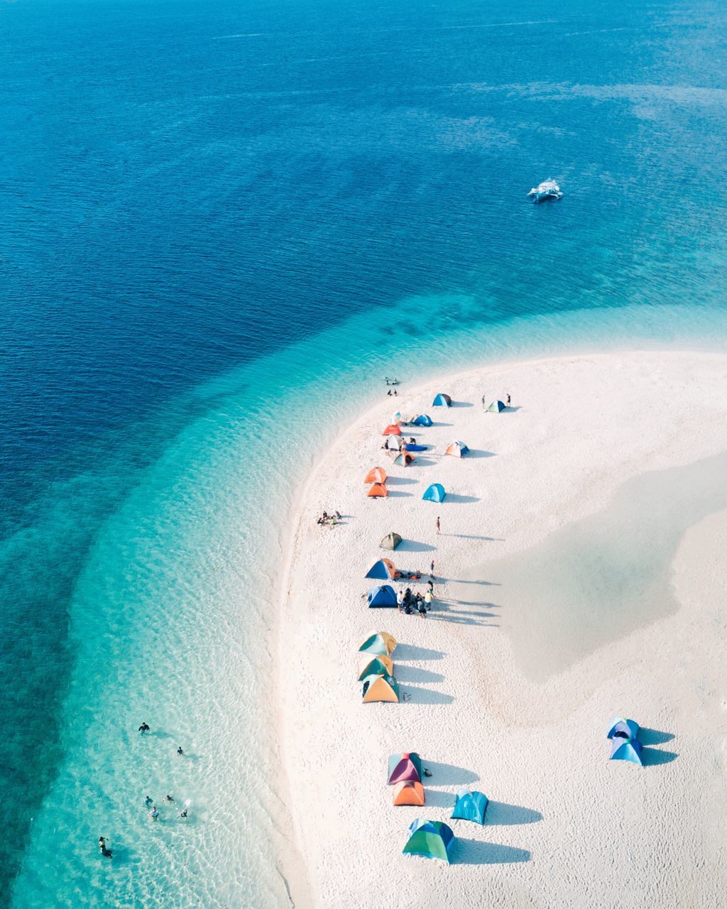 water, sea, beach, land, sand, blue, high angle view, vacations, nature, trip, holiday, beauty in nature, day, scenics - nature, sunlight, incidental people, tranquility, summer, group of people, turquoise colored