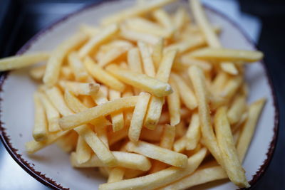 Close-up of noodles with fries and rice in plate