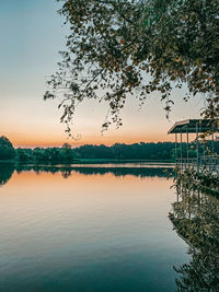 Scenic view of lake against sky during sunrise 