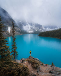 Scenic view of lake by mountains against sky