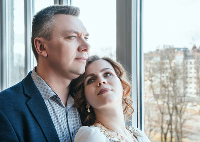 Couple looking at window from apartment