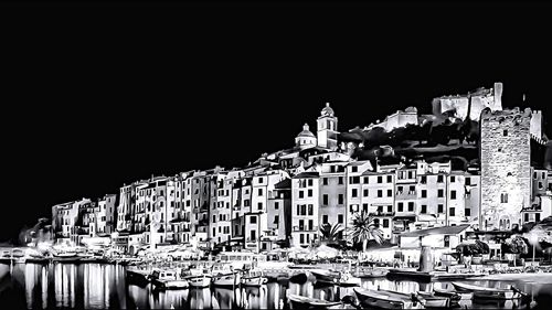 Buildings against clear sky at night