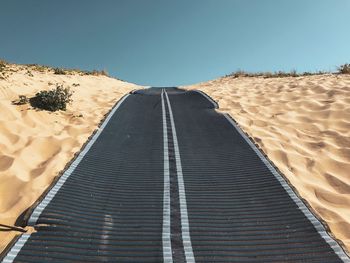 Scenic view of desert against clear blue sky