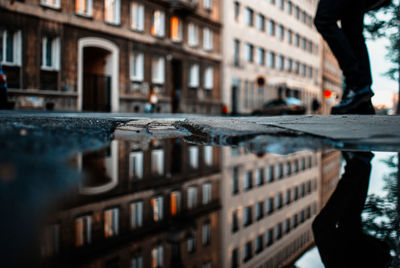 Reflection of built structure in puddle