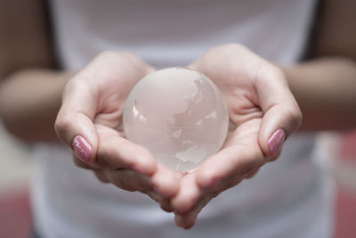 Close-up of woman hands holding globe