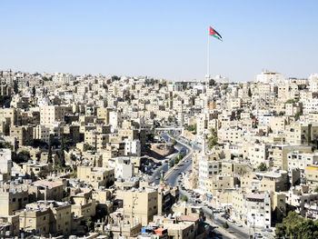 High angle view of flag in city against clear sky