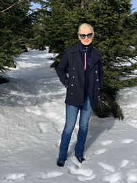Portrait of man wearing sunglasses standing in snow