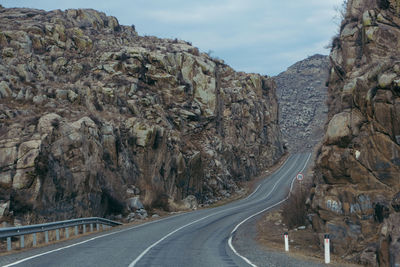 Road amidst mountains against sky