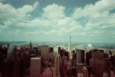 Cityscape against cloudy sky