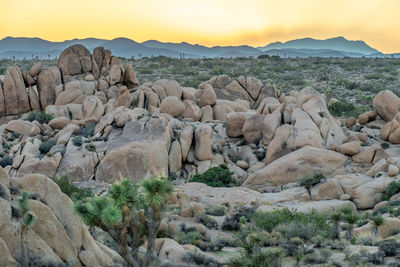 Scenic view of rock formations against sky during sunset