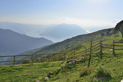 Scenic view of field and mountains against sky