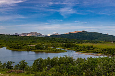 Scenic view of lake and mountains against sky