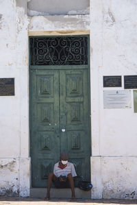 Woman sitting outside building