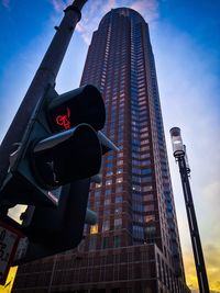 Road sign with skyscraper in background