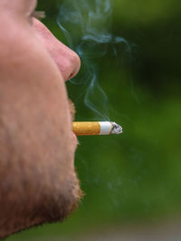 Close-up of hand holding cigarette