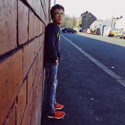 Portrait of young man standing on road
