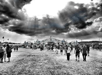 Crowd on road against sky