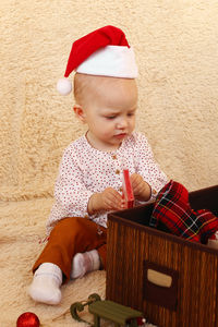 Portrait of cute girl sitting on floor
