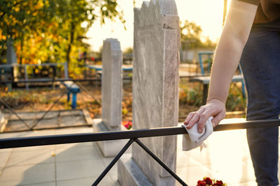 Midsection of person standing by railing