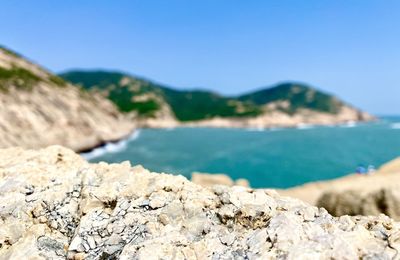 Scenic view of sea against clear blue sky