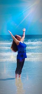 Rear view of woman standing on beach