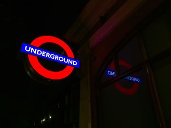 Low angle view of road sign at night