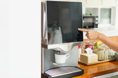 Cropped image of person washing machine
