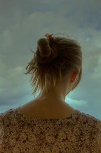 Close-up of cow against cloudy sky