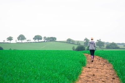 Man standing on field against clear sky