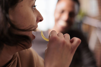 Close-up of woman eating chip