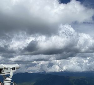 Scenic view of clouds and mountains against sky
