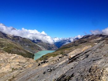 Scenic view of mountains against blue sky