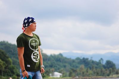 Full length of boy standing against sky