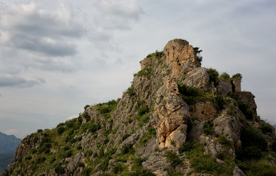 Rock on cliff against sky