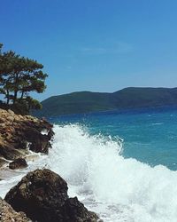 Scenic view of sea against clear blue sky