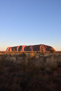 Built structure on rock against clear sky