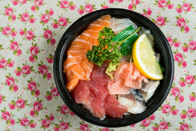 Directly above of chirashi served in bowl on table