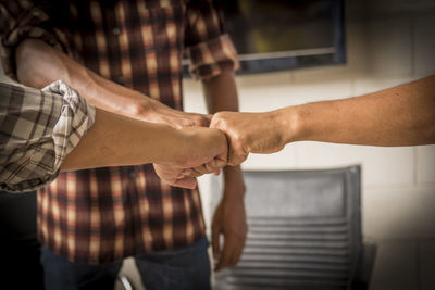 Cropped image of men bumping fist