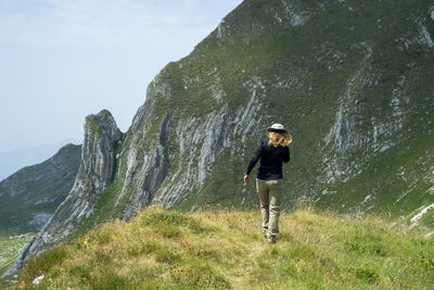 Rear view of man standing on mountain
