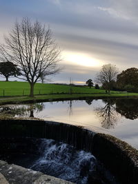 Scenic view of lake against cloudy sky