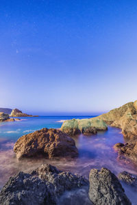 Scenic view of sea against clear blue sky