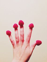 Close-up of cropped hand over white background
