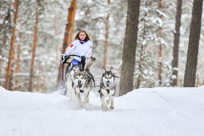 Woman with dog in snow