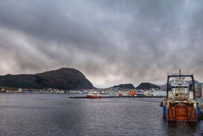 Scenic view of cloudy sky over commercial dock