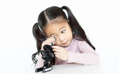 Portrait of a smiling girl over white background