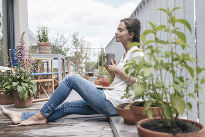 Woman relaxing on balcony