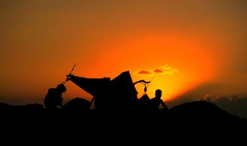 Silhouette of trees against sky at sunset