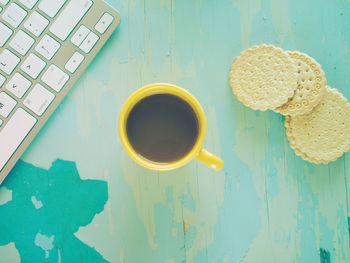 Directly above shot of coffee and cookies on table