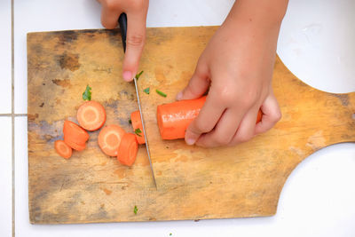 High angle view of baby feet on cutting board