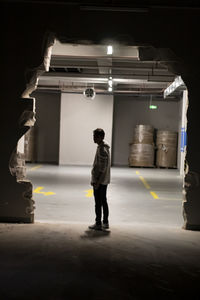 Rear view of man standing in subway
